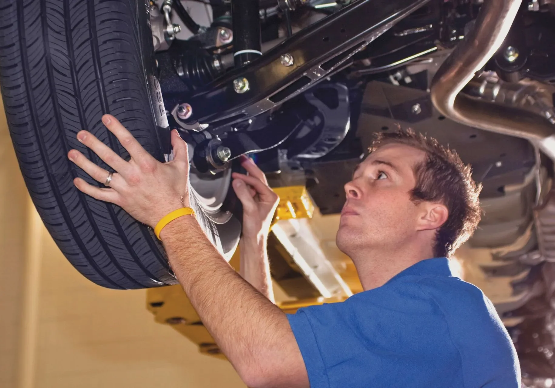 Technician examining vehicle tire
