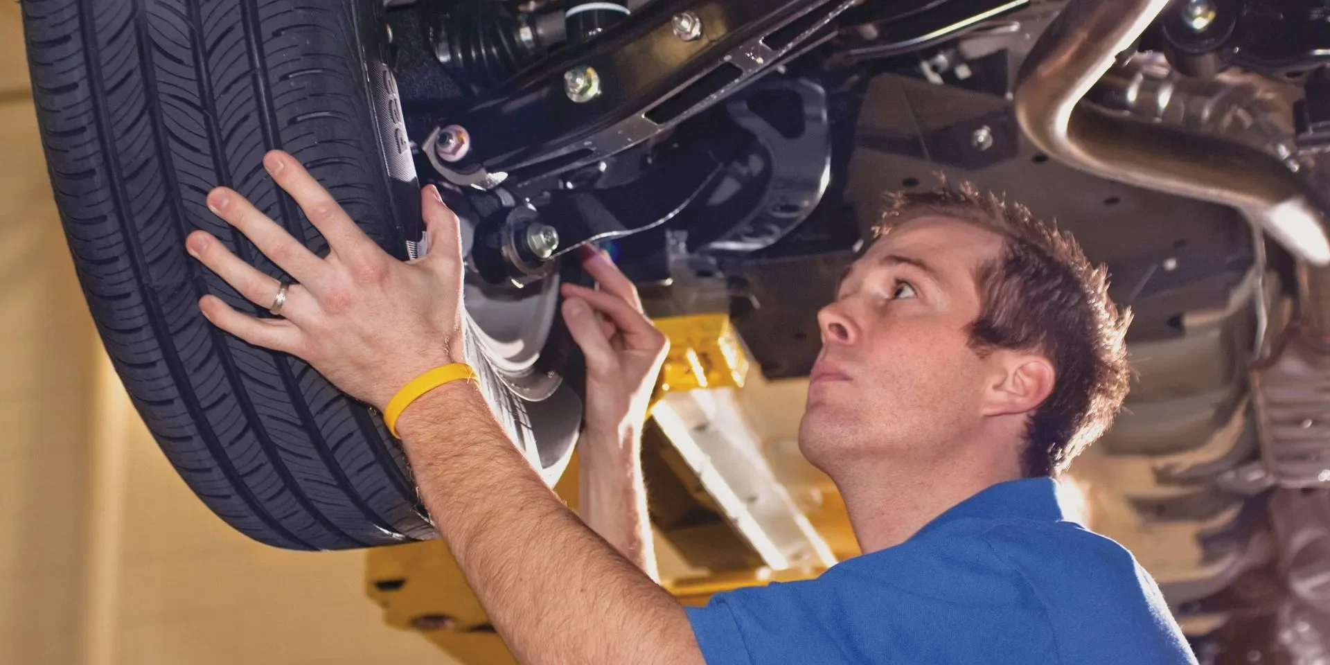 Technician examining vehicle tire